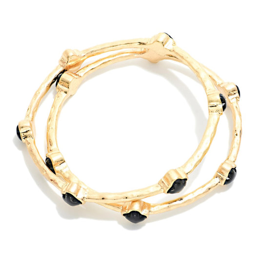 Set Of Two Hammered Metal Tone Bangle Bracelet Featuring Glitter Resin Clover