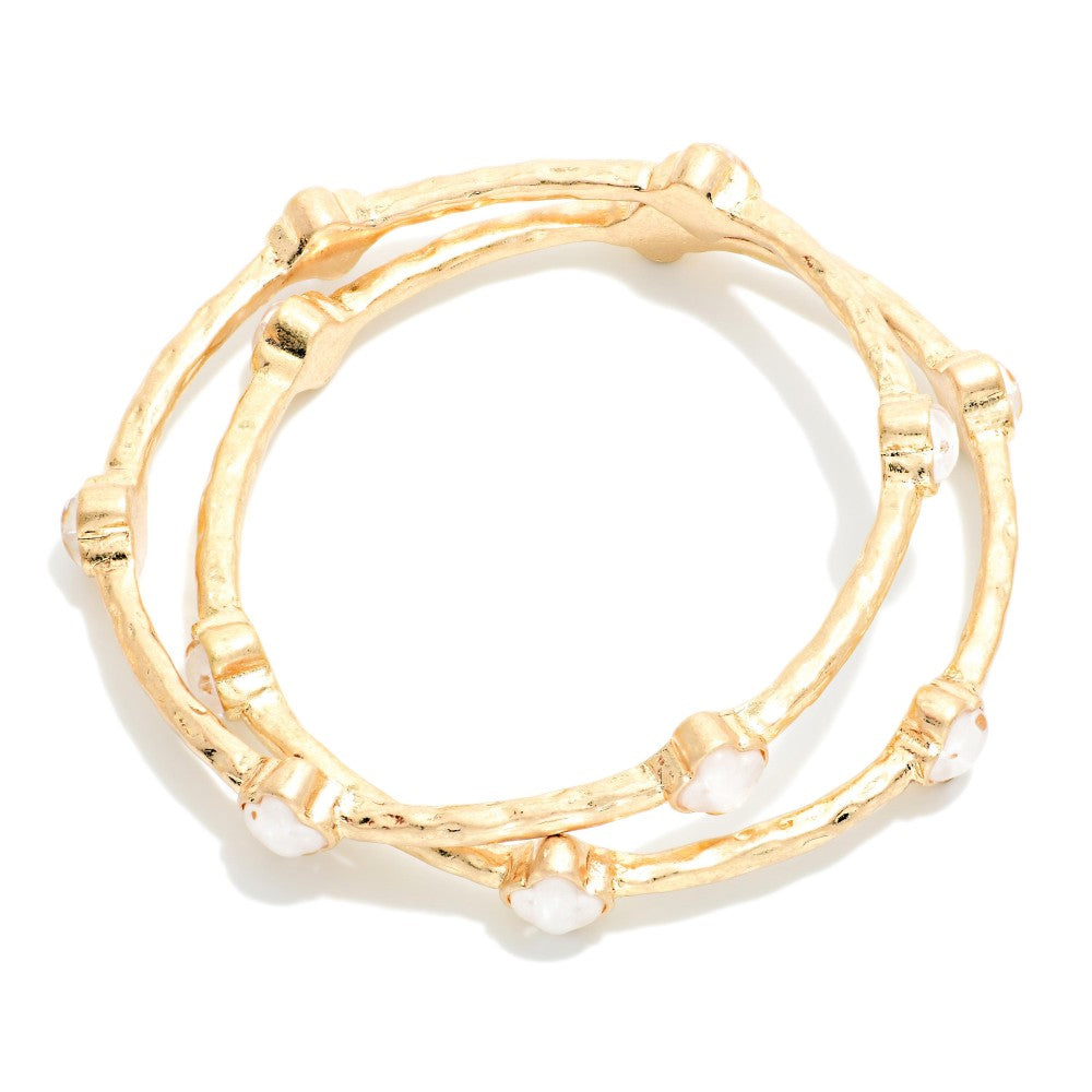 Set Of Two Hammered Metal Tone Bangle Bracelet Featuring Glitter Resin Clover