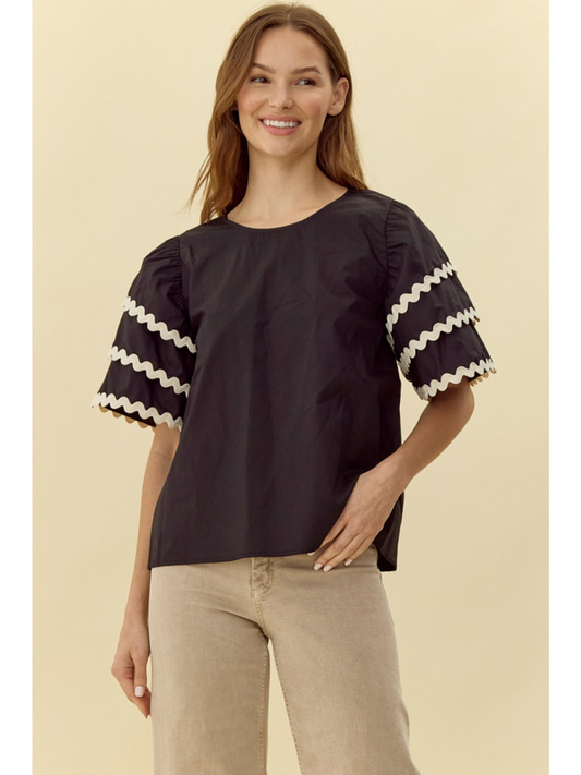 Solid top with U-neck, back buttoned closure, short puffed layer sleeves, and wave trim detail.
